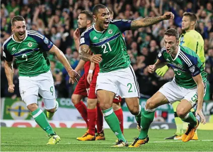  ??  ?? Good Evans: the West Brom defender (far right) wheels away after his goal for Northern Ireland