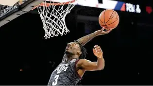  ?? David Becker / Getty Images ?? Texas A&M’S Quenton Jackson goes up for a dunk after one of his five steals against Butler on Tuesday. The Aggies will play for fifth place at the Maui Invitation­al on Wednesday night.
