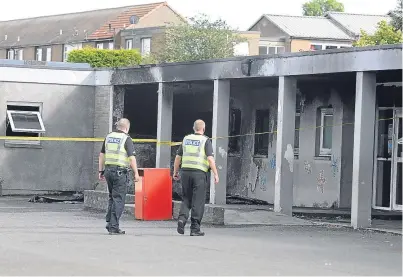  ?? Picture: David Wardle. ?? Police checking the fire damage at Torbain Primary School. Now parents are waiting for news if their children can start school on Wednesday.