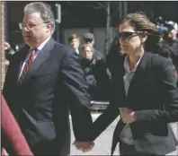  ?? The Associated Press ?? SENTENCED: Manuel and Elizabeth Henriquez arrive at federal court on April 3, 2019, in Boston to face charges in a nationwide college admissions bribery scandal. Henriquez and her husband were charged with paying $400,000 in bribes to get their oldest daughter into Georgetown as a bogus tennis recruit in 2016. They also paid bribes to have someone cheat on their daughters' college entrance exams, authoritie­s said.