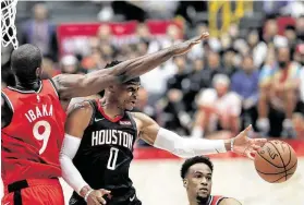  ?? Takashi Aoyama / Getty Images ?? Rockets guard Russell Westbrook (0), who scored 22 points, dishes off a pass as Toronto’s Serge Ibaka defends during Thursday’s preseason game in Tokyo.