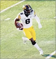  ?? Charles Rex Arbogast / Associated Press ?? Iowa wide receiver Ihmir Smith-Marsette carries the ball against Illinois on Dec. 5.