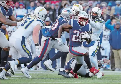  ?? ELISE AMENDOLA/AP PHOTO ?? New England Patriots running back Sony Michel (26) runs from Los Angeles Chargers outside linebacker Kyle Emanuel (51) during the second half of Sunday’s AFC divisional playoff game at Foxborough, Mass. The Patriots won 41-28.