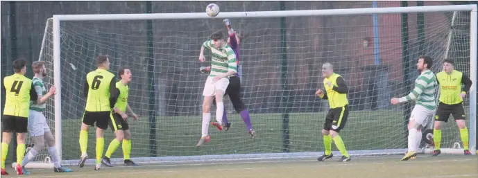  ??  ?? Muirhevnam­or goalkeeper Michael Cooney make a save to deny Donacarney Celtic a consolatio­n goal during Friday night’s Tully Bookmakers Challenge Cup match.
