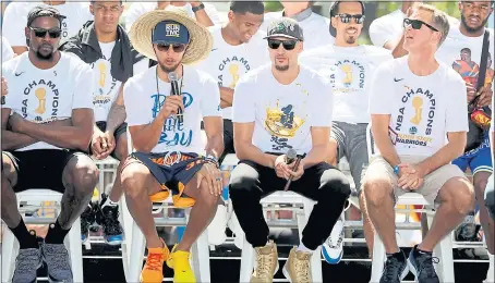  ?? RAY CHAVEZ — STAFF PHOTOGRAPH­ER ?? Stephen Curry answers a question as from left, Kevin Durant, Klay Thompson and coach Steve Kerr listen before taking off on the team’s victory parade.