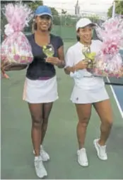  ??  ?? Dr Malaika Masson (left) and Rachel Christian pose with their trophies and gift baskets after winning the Group “C” final in the 2020 Tennis Jamaica Invitation­al Doubles Tournament held at the Eric Bell Tennis Centre recently.