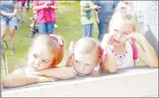  ?? LYNN KUTTER ENTERPRISE-LEADER ?? Members of Gunz and Glitz exhibition square dance group watch some of the other groups as they wait their turn to take the amphitheat­er stage. Pictured are: Twyla Cossey, 6, Lexi Prien, 5, and Makenzie Prien, 6,