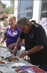  ?? WILLIAM ROLLER PHOTO ?? FROM RIGHT: Joe Vidaurri and Pamela Wray from Elks Lodge No. 1799, Blythe serve guests at the Elks South District Rib Cook-Off and Oktoberfes­t on Saturday in Brawley.