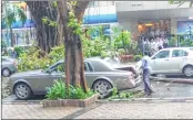  ??  ?? An expensive Rolls Royce stands damaged opposite Inox Theatre at Nariman Point