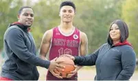  ?? STEPHEN M. DOWELL/ ORLANDO SENTINEL ?? West Oaks player AJ Neal, middle, is pictured with his mom, Diana Gillion and stepdad, Kenny Gillion, at West Oaks Academy on Jan. 26. Kenny and Diana are coaches at the school.