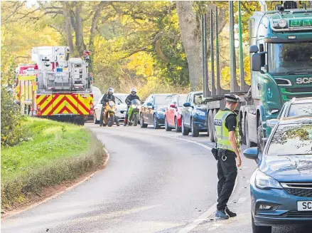  ??  ?? Emergency services and a queue of cars at the scene of the crash on the A93 at Guildtown, near Perth.