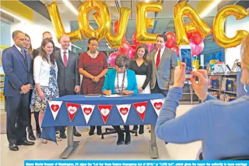  ??  ?? Mayor Muriel Bowser of Washington, DC signs the “Let Our Vows Endure Emergency Act of 2019,” or “LOVE Act”, which gives the mayor the authority to issue marriage licenses during the partial federal government shutdown during a signing ceremony in Washington on Jan 11, 2019. — AFP