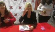  ?? RICK MCCRABB/STAFF ?? After her speaking engagement Thursday night at Miami University Middletown, activist Erin Brockovich signed copies of her second book, “Superman’s Not Coming.”