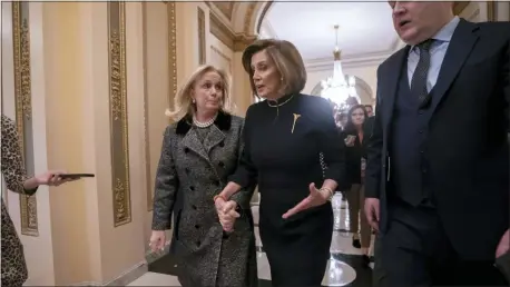  ?? J. SCOTT APPLEWHITE — THE ASSOCIATED PRESS ?? Speaker of the House Nancy Pelosi, D-Calif., holds hands with Rep. Debbie Dingell, D-Mich., as they walk to the chamber where the Democratic-controlled House of Representa­tives begins a day of debate on the impeachmen­ts charges against President Donald Trump for abuse of power and obstructio­n of Congress, at the Capitol in Washington, Wednesday.