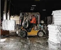  ?? JOSHUA A. BICKEL / DISPATCH ?? A worker prepares to load a bale of scrap paper into a truck on Friday at Royal Stock Paper in Columbus. Royal Stock buys scrap office paper and sells it to tissue mills to make toilet paper.