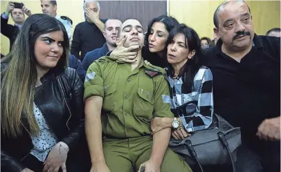  ?? AP ?? Sgt. Elor Azaria waits with his parents for the verdict inside a military court in Tel Aviv, Israel, on Wednesday.