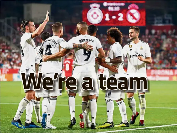  ??  ?? Huddle up: Real Madrid’s Karim Benzema (centre) celebratin­g with teammates after scoring a goal in the La Liga match against Girona at the Montilivi on Sunday. — AFP