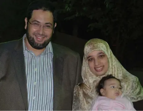  ?? AHMAD ATTIA PHOTO ?? Khaled Al-Qazzaz, left, with wife, Sarah Attia and their baby, Tahrir. Al-Qazzaz had volunteere­d for Morsi’s Freedom and Justice Party before his arrest.