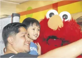  ?? LYNN CURWIN ?? James Valinpora quickly snapped a selfie when he and his almost four-year-old son, Aeden, met Elmo at the Truro library.