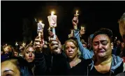  ?? STEPHANIE KEITH / GETTY IMAGES ?? Mourners attend a vigil for the victims of the fatal limousine crash on Monday in Amsterdam, N.Y. 20 people were killed in the crash.