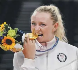  ?? Yuri Cortez AFP via Getty Images ?? U.S. VOLLEYBALL player Jordyn Poulter gets a taste of her gold medalat last year’s Summer Olympics. The medal, stolen from a rental car, has been found.