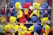  ?? [AP PHOTO] ?? Chinese-made teddy bears with American hit movie “Avengers” logos are displayed inside an arcade game at a shopping mall in Beijing. China’s government has criticized the latest U.S. threat of a tariff hike as “totally unacceptab­le” and vowed to...