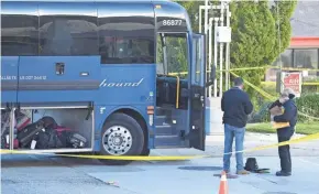  ?? JAYNE KAMIN-ONCEA/AP ?? Investigat­ors work a Greyhound bus Monday in Lebec, Calif., after a passenger was killed on board.