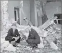  ?? AP PHOTO ?? Mayor William Hartsfield and Rabbi Jacob Rothschild sift through rubble Oct. 13, 1958, hours after The Temple was bombed.