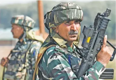  ?? (AFP) ?? Paramilita­ry troopers stand guard during a previous operation against militants at Hajin village of Kashmir's Bandipora district, on Wednesday