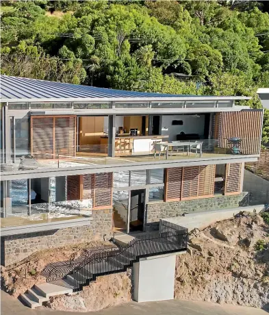  ??  ?? Borrmeiste­r Architects specified sliding timber screens for Red Rock House in Sumner, which won an NZIA Canterbury Housing Award this year. The screens keep out the sun on the hottest days.