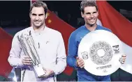  ?? AP ?? Roger Federer of Switzerlan­d (left) and Rafael Nadal of Spain pose with their trophies after the award ceremony for the Shanghai Masters tennis tournament at Qizhong Forest Sports City Tennis Center in Shanghai, China, yesterday. Federer defeated Nadal...