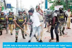  ?? — AFP ?? GALORE, India: In this picture taken on Dec 19, 2019, policemen with “lathis” beat a protester during a demonstrat­ion against India’s new citizenshi­p law.
