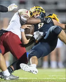  ?? Steph Chambers/Post-Gazette ?? Penn Hills' Jordy Boswell flattens Mars quarterbac­k Tyler Kowalkowsk­i earlier this season. The Indians defense will need to step up one more time against Manheim Central.