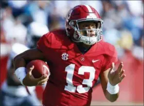  ?? BUTCH DILL — ASSOCIATED PRESS ?? Alabama quarterbac­k Tua Tagovailoa carries during the first half against Citadel on Nov. 20 in Tuscaloosa, Ala.