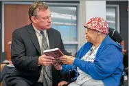  ?? THE MORNING JOURNAL FILE ?? Lorain resident Rhoda Lee shows then Lorain City Schools Superinten­dent Dr. Jeff Graham a copy of Samuel Betances’ book “Winning the Future Through Education One Step at a Time” prior to the start of the Lorain City School Board and Lorain Academic Distress Commission’s joint meeting, July, 17, 2017. Graham has applied to become the next CEO of Lorain City Schools.