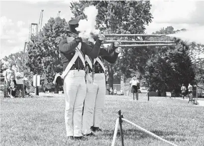  ?? KENNETH K. LAM/BALTIMORE SUN ?? Members of the Fort McHenry Guard fire four volleys of musket shots to commemorat­e the 400-year anniversar­y of the arrival of African slaves in colonial America during a “Day of Healing” ceremony at Fort McHenry National Monument and Historic Shrine.