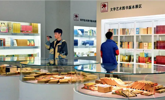  ??  ?? On October 9, 2019, the New China Book Exhibition on the past 70 Years opens in Beijing. The exhibition displays various literary works since the founding of the People’s Republic of China.