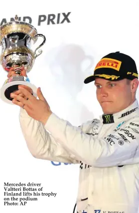  ??  ?? Mercedes driver Valtteri Bottas of Finland lifts his trophy on the podium Photo: AP