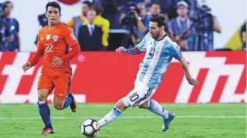  ?? Rex Features ?? Lionel Messi in action against Chile during the Copa America final last June. Messi has served one of a four-game internatio­nal ban for abusing a referee in a World Cup qualifier last month.