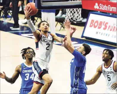  ?? David Butler II / Pool Photo via AP ?? UConn’s James Bouknight (2) drives the ball to the basket against Creighton in the second half on Sunday.