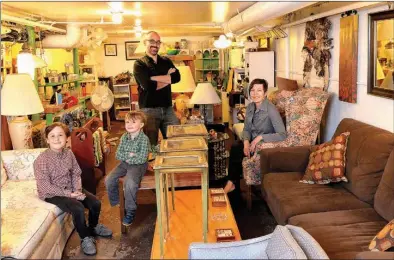  ?? Tribune News Service ?? The Basilone family poses in the basement of their store, Thrift & Thrive, in Chicago. Pictured are, from left, Liam, Evan, Joe and Melissa. The family went the entire year 2013 without buying a single new item, with the exception of food and hygienic...