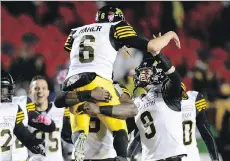  ?? JUSTIN TANG/ THE CANADIAN PRESS ?? Hamilton Tiger-Cat Brett Maher celebrates after kicking the game-winning field goal against Ottawa on Friday.