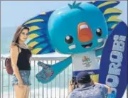  ?? AFP ?? A woman poses for photograph­s with "Borobi", the official mascot of the Commonweal­th Games.