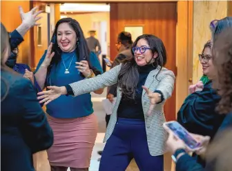  ?? EDDIE MOORE/JOURNAL ?? Rep. Andrea Romero, D-Santa Fe, and other legislator­s are greeted by advocates after Senate Bill 13, a proposal to protect abortion providers in New Mexico from out-of-state liability, was passed Friday in the House.