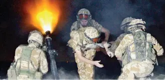  ??  ?? On the frontline: British soldiers fire mortar flares on patrol near Basra in 004