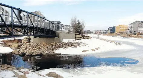  ?? PHOTOS: RYAN MCLEOD ?? A six-year-old boy is dead and his 10-year-old brother is being treated for hypothermi­a in hospital after they fell through the ice on this overland canal system in Airdrie, Alta., on Monday. Officials are warning people to stay off the ice, which is...