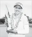  ?? HARRY HOW GETTY IMAGES ?? Canadian Brooke Henderson holds the winner’s trophy.