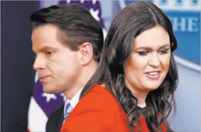  ?? Pablo Martinez Monsivais ?? The Associated Press New White House press secretary Sarah Huckabee Sanders and new White House communicat­ions director Anthony Scaramucci pass at the Friday press briefing at the White House.