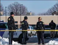  ?? (AP/The Des Moines Register/Zach Boyden-Holmes) ?? Law enforcemen­t officers stand outside a school housing an educationa­l program affiliated with the Des Moines, Iowa, school district following a shooting there Monday.