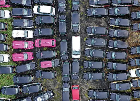  ?? AFP ?? London cabs parked in a field in Epping. Picking up a fare has become so hard for London’s legendary black cabs that many taxis are being mothballed.